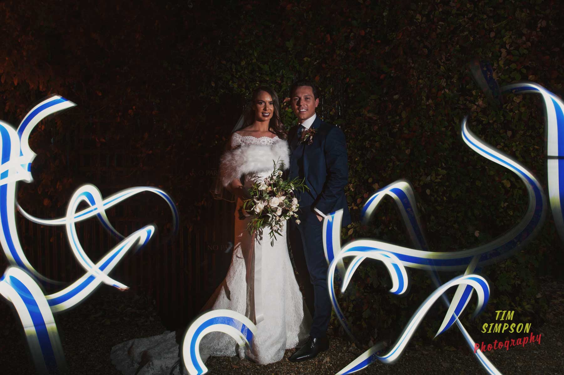 bride and groom surrounded by light painting