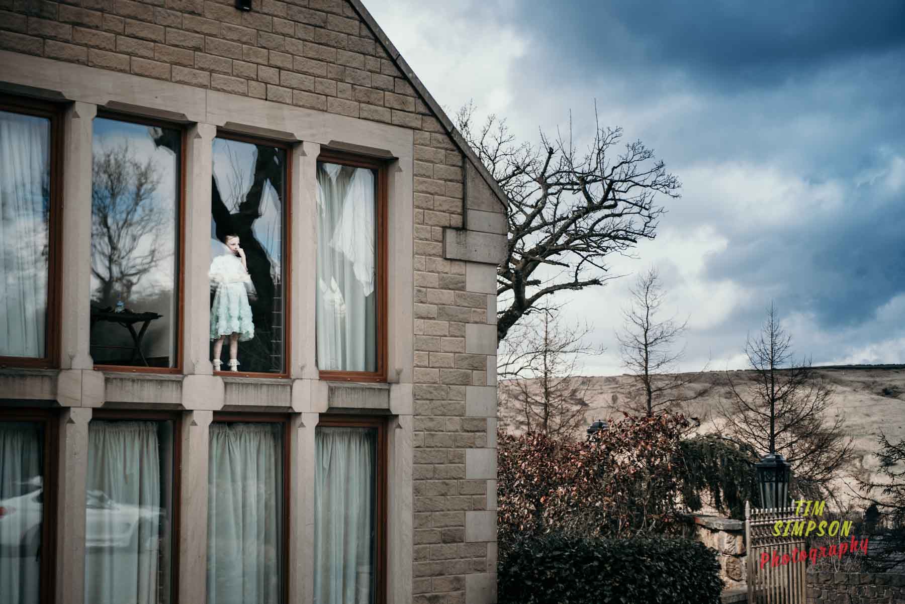 lone bridesmaid in window