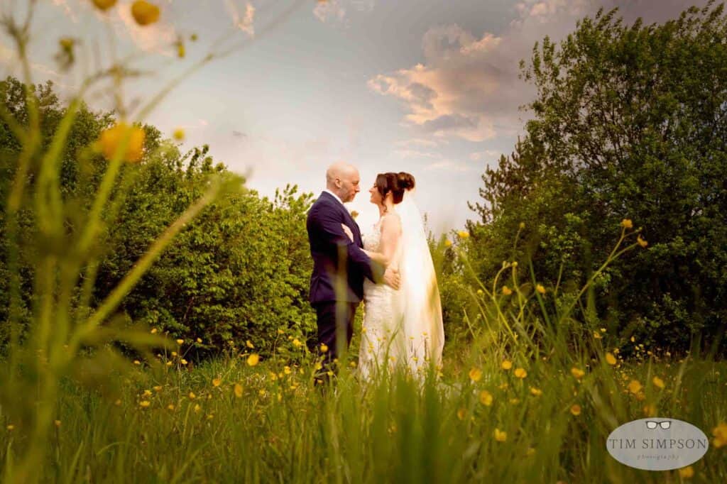 Bride and groom in a buttercup meadow